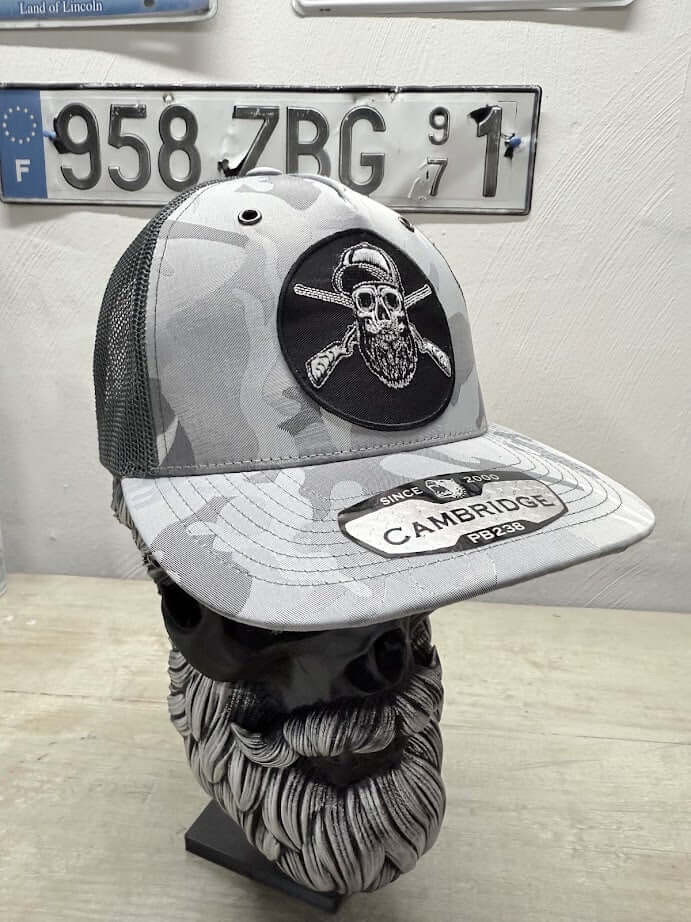 Bearded Skull Hunting Trucker Hat with skull logo and camouflage pattern, unique accessory for stylish men.