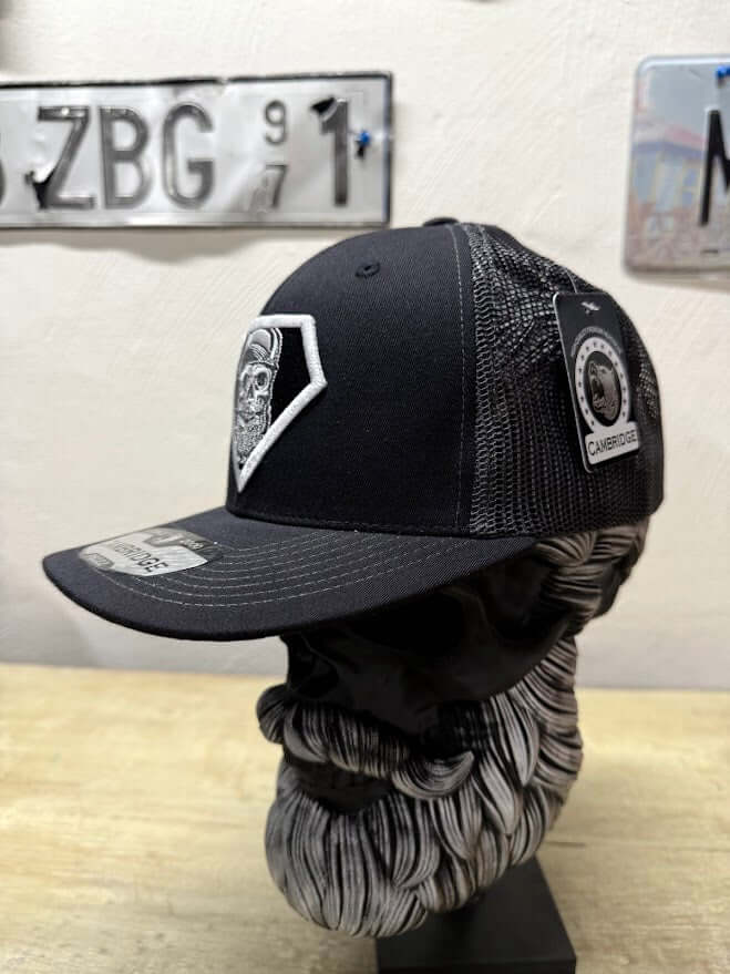 Super Beard Man Black Out Trucker Hat displayed on a bust model, featuring a stylish black design and mesh back.