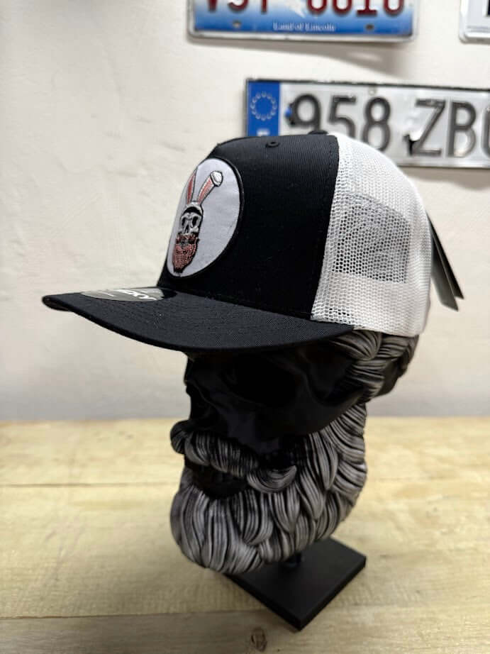Easter Bunny Beard Guy Trucker Hat featuring embroidered bunny and skull design on a black and white trucker hat.