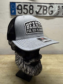 Bearded For HIS Pleasure trucker hat displayed on a bearded mannequin, showcasing its stylish design and quality.
