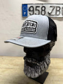 Bearded For HIS Pleasure trucker hat displayed on a beard-themed mannequin, showcasing its stylish design.