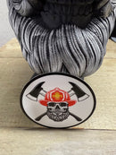 Fireman beard skull sticker with crossed axes and firefighter helmet, showcasing strength and bravery.