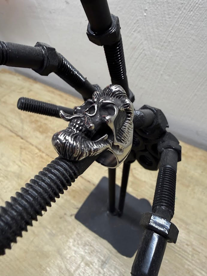 Bearded Skull Guy Men's Stainless Steel Heavy Duty Ring displayed on industrial metal structure.